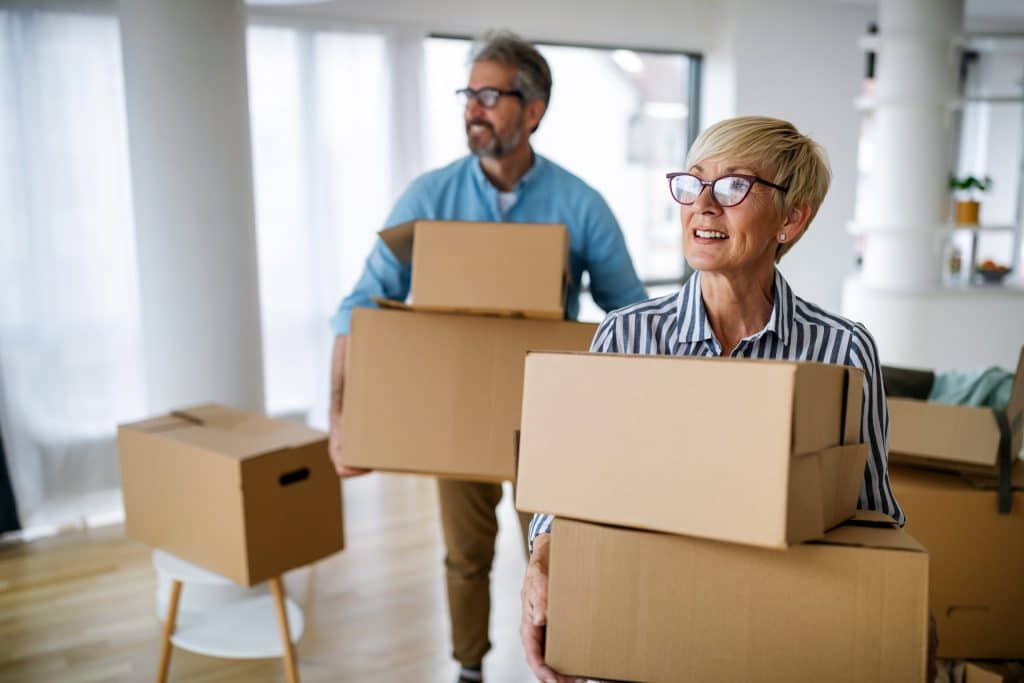 Senior couple moving boxes into Providence House Assisted Living