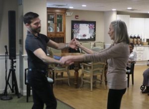 Michael J. Winward dancing with an active senior woman at Providence House Assisted Living in Brighton, MA